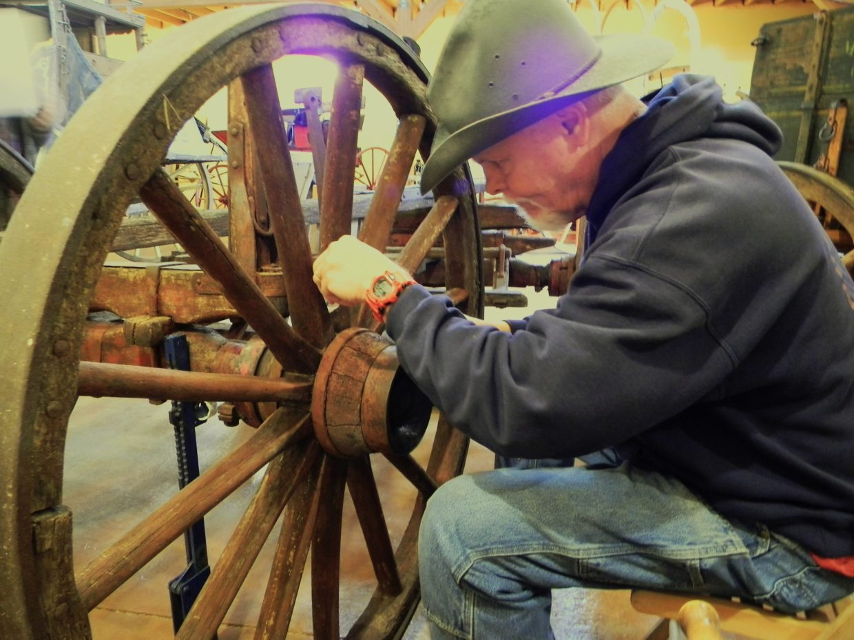 Curator Jerry Bowman working on a wheel hub